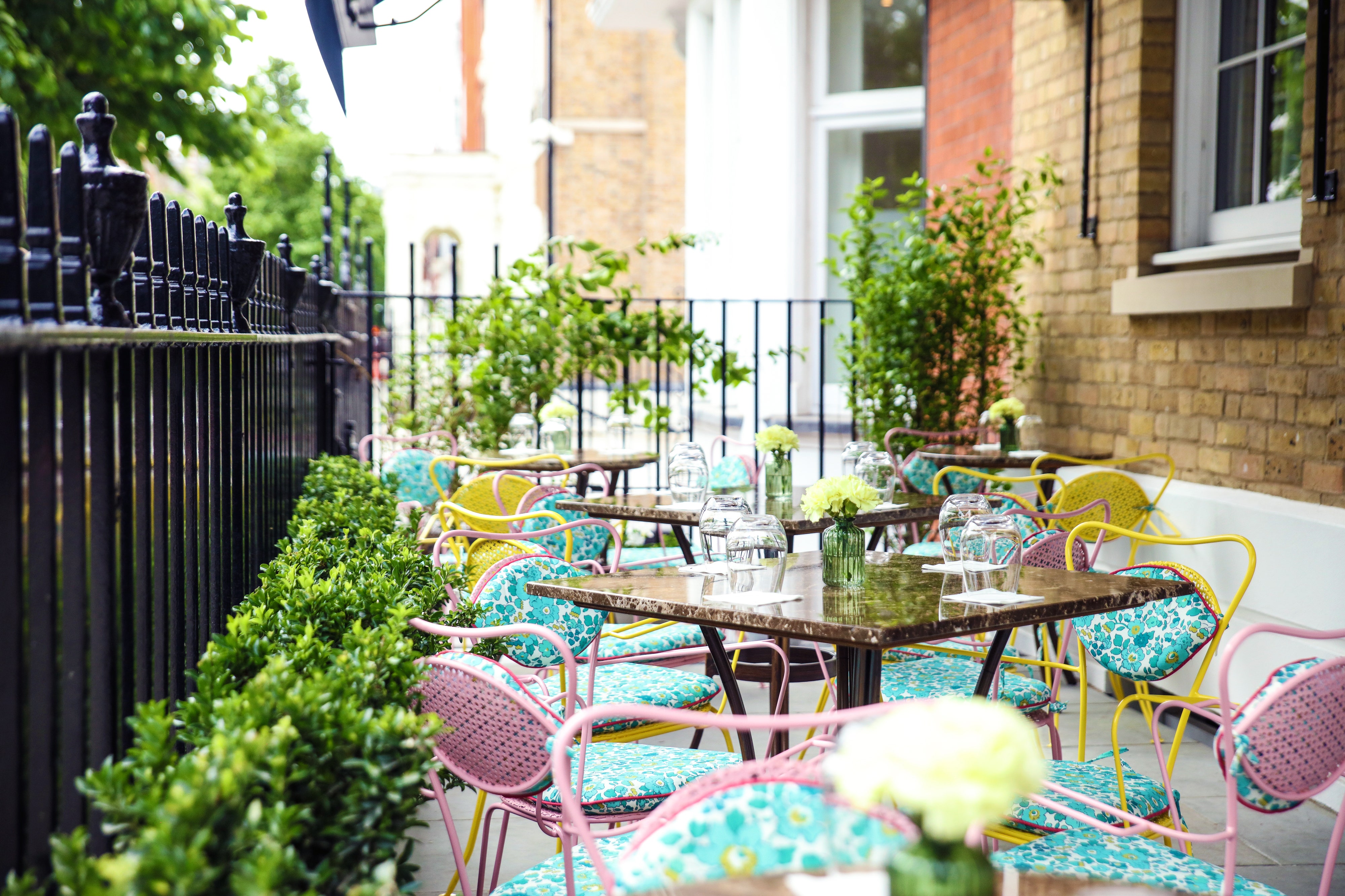 Charming outdoor terrace with vibrant seating for casual meetings and networking events.