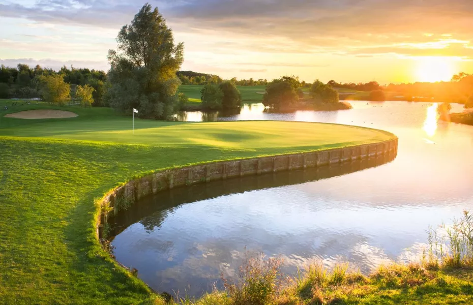 9 Hole Academy Course at sunset, serene water feature, ideal for outdoor events and retreats.