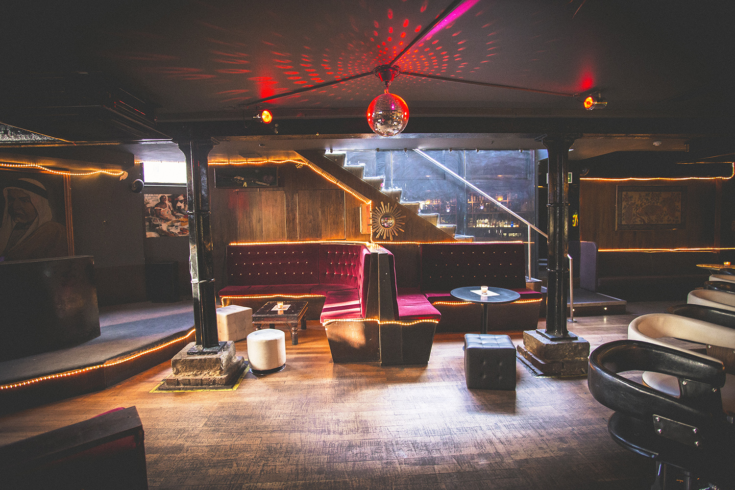 Stylish Hoxton Basement event space with plush seating and disco ball for gatherings.