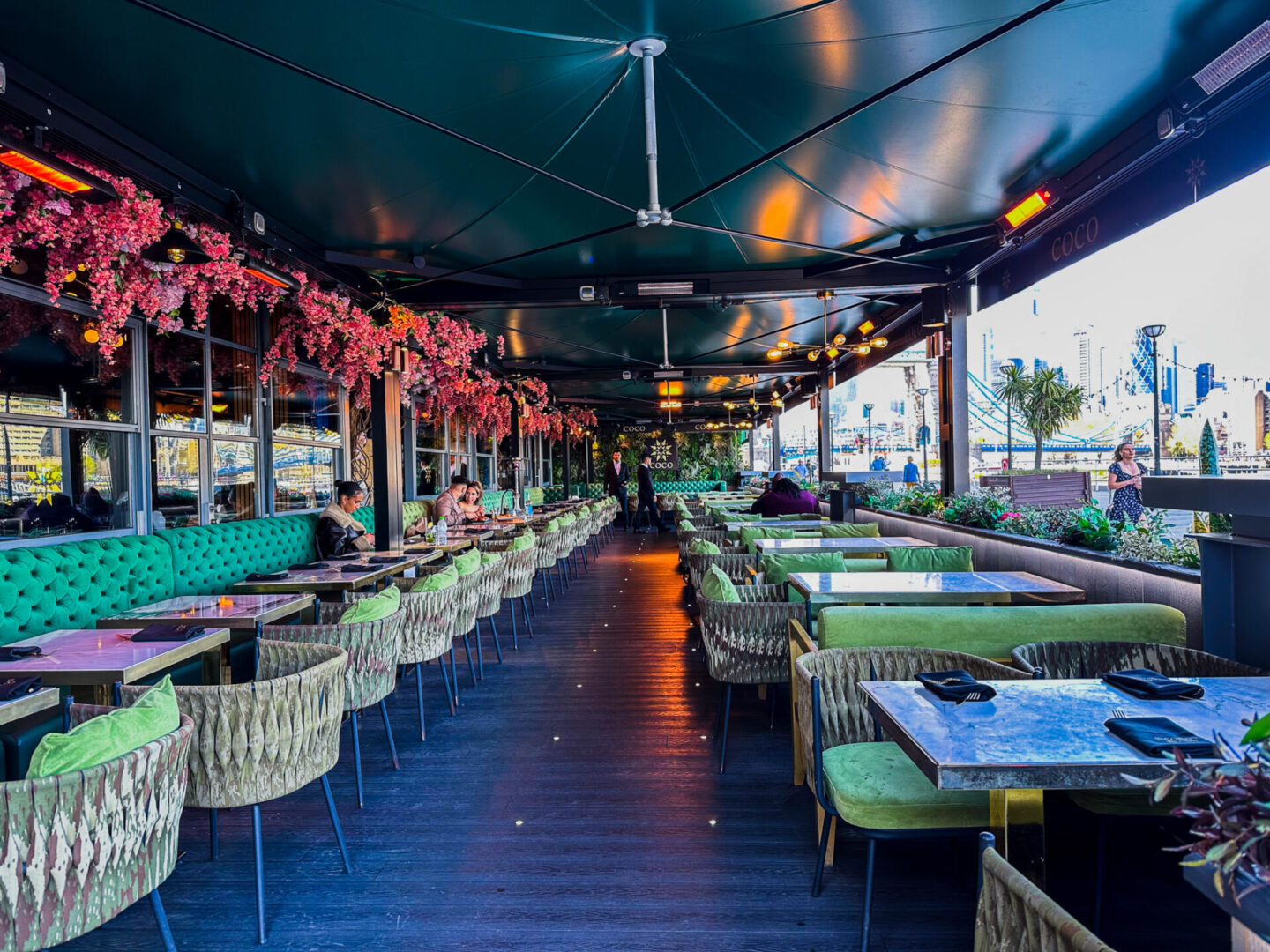 Vibrant COCO Restaurants bar with lush greenery, ideal for networking events and private parties.