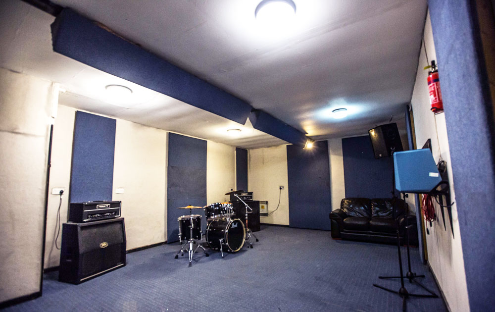 Soundproof recording studio with acoustic panels for workshops and meetings.