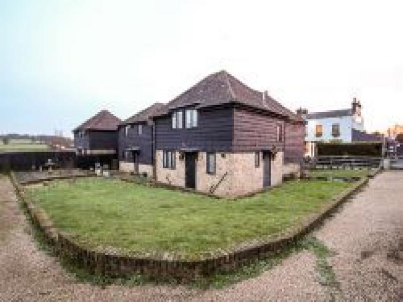 Charming garden venue with rustic buildings for corporate retreats and team-building events.