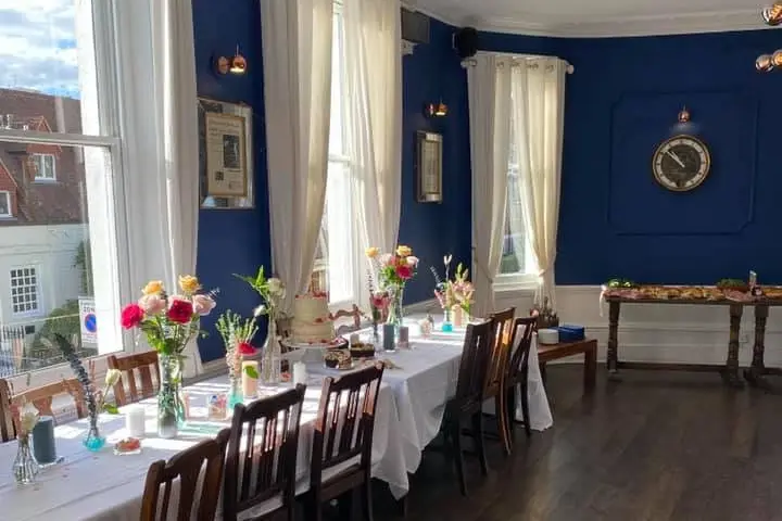 Private meeting room with floral centerpieces, ideal for workshops and networking events.