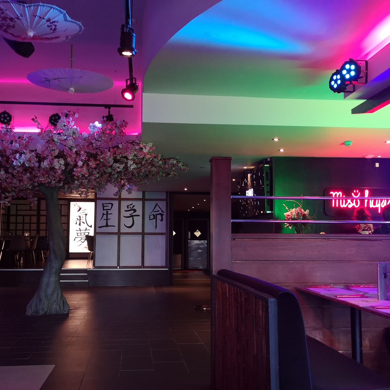 Vibrant FOMO Bar & Restaurant with cherry blossom tree, perfect for events in London.