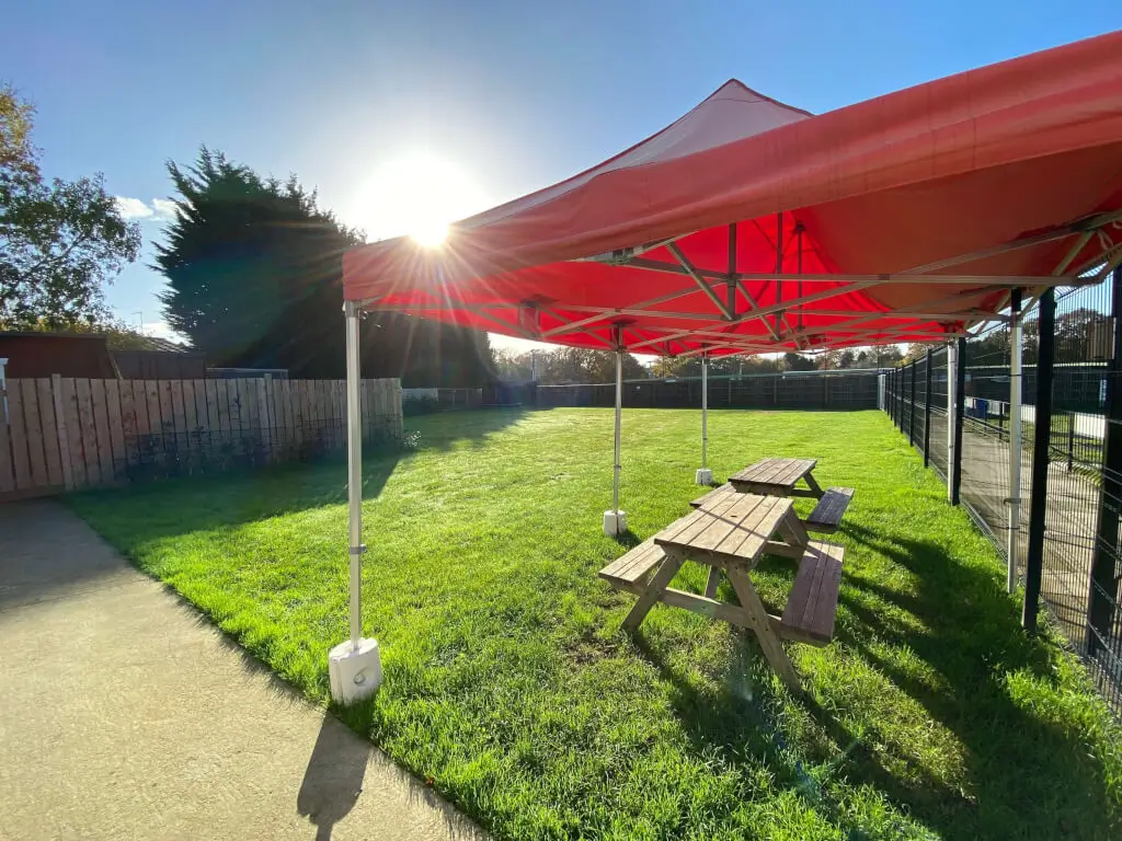 Outdoor Pavilion with red canopy, ideal for casual gatherings and team-building events.