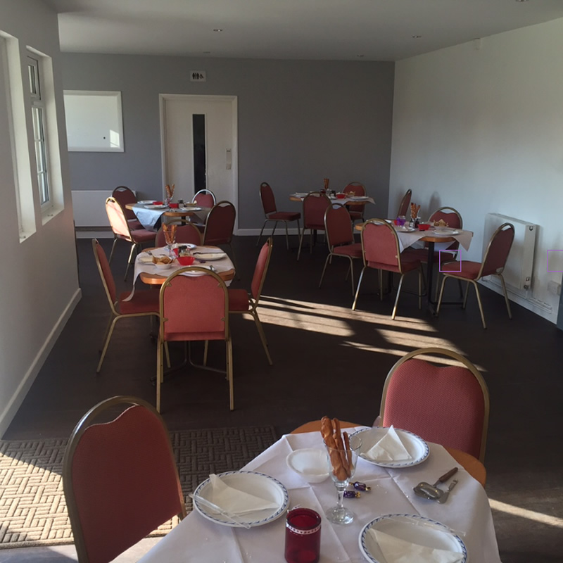 Meeting space at The Pavilion with round tables and pink chairs for workshops.
