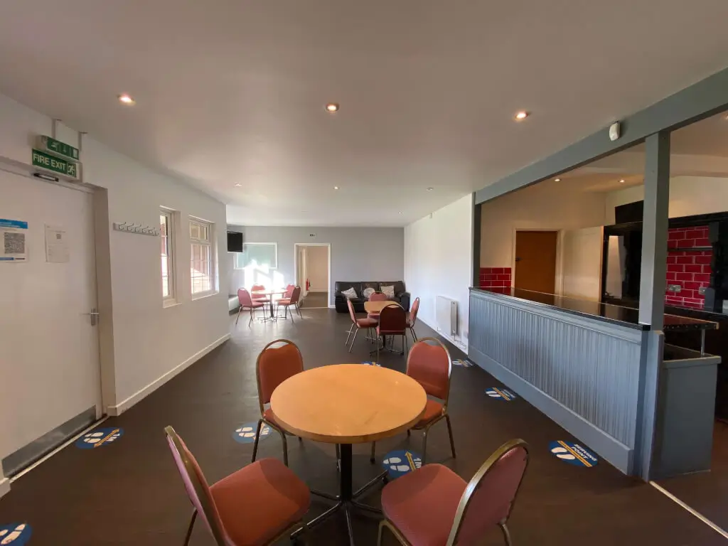 Versatile event space with round table, ideal for meetings and workshops at The Pavilion.