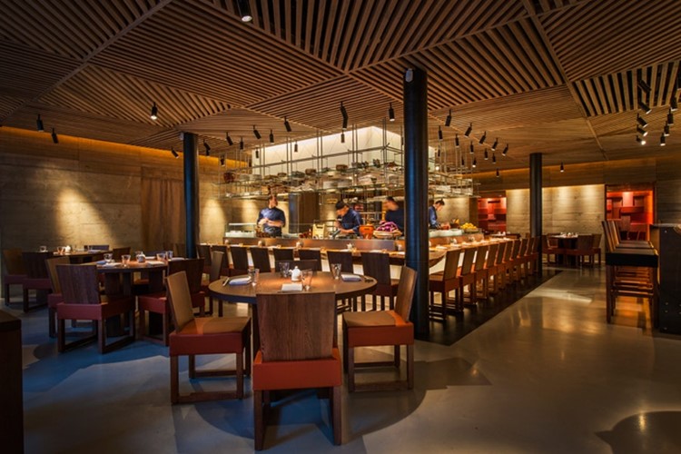 Modern restaurant interior with warm lighting, ideal for corporate events and gatherings.