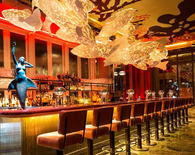 Vibrant bar with mermaid sculptures, perfect for upscale events and cocktail receptions.
