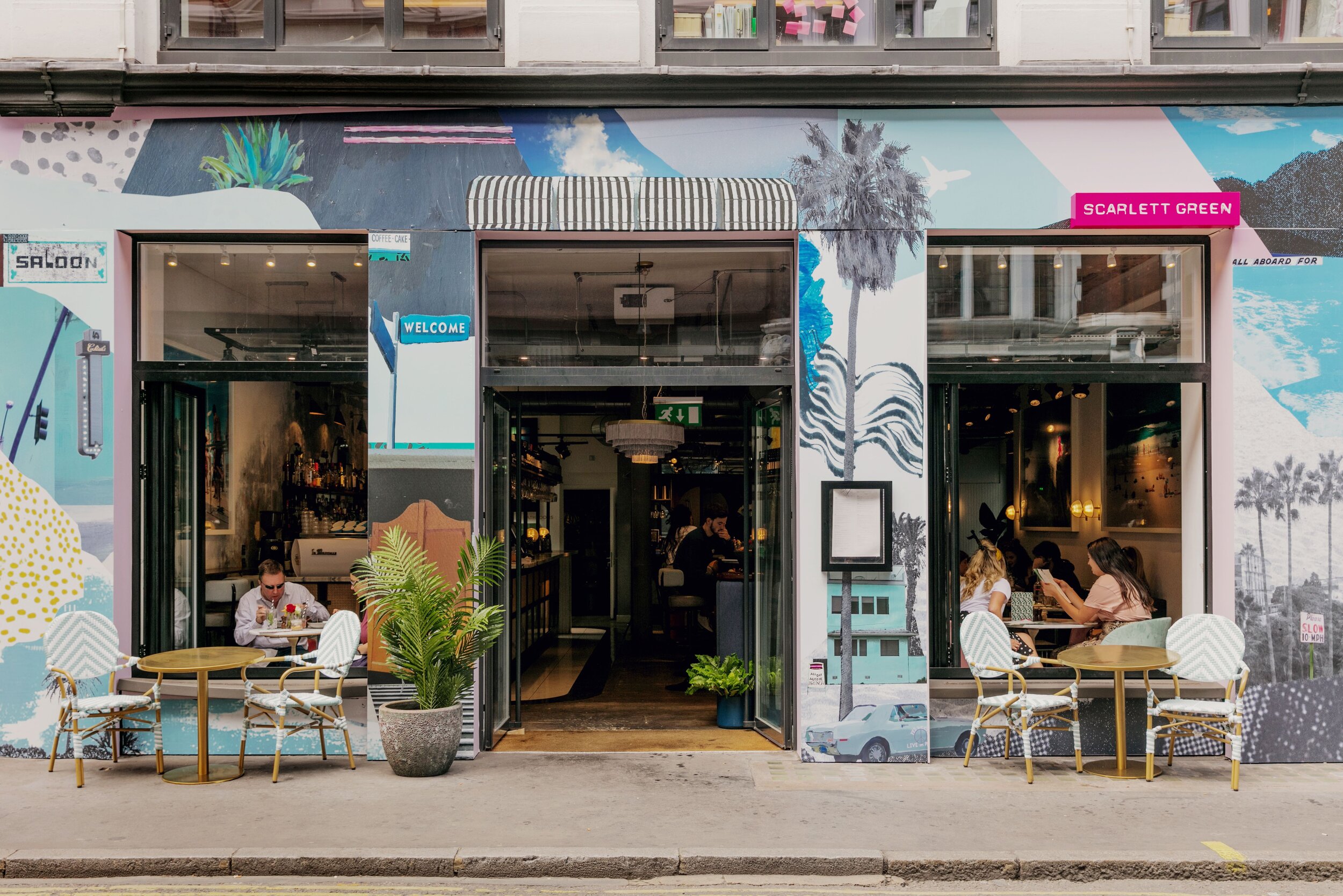 Vibrant restaurant exterior with mural, ideal for casual meetings and networking events.