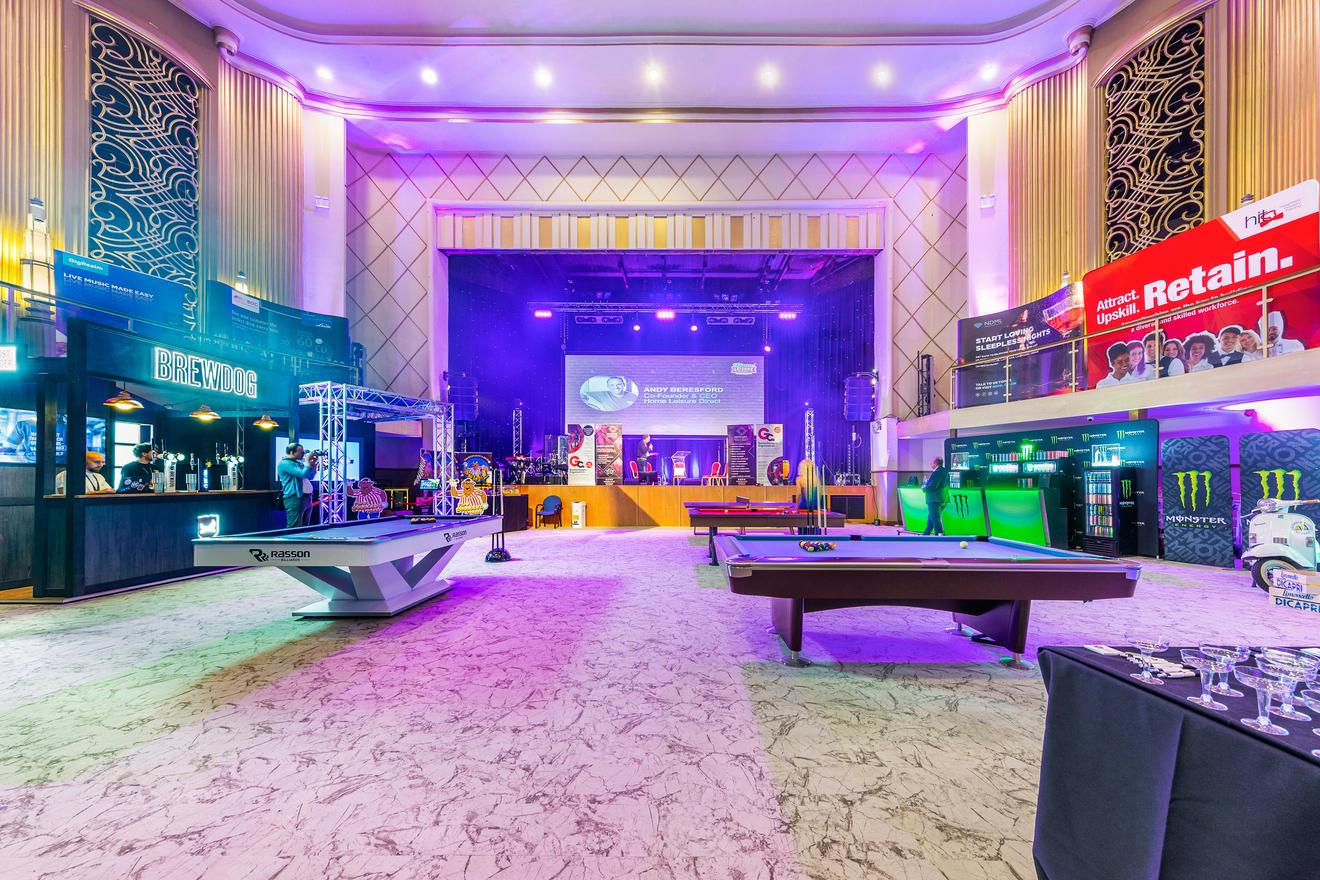 Vibrant event space in The Lighthouse Theatre with stage, ideal for corporate gatherings.