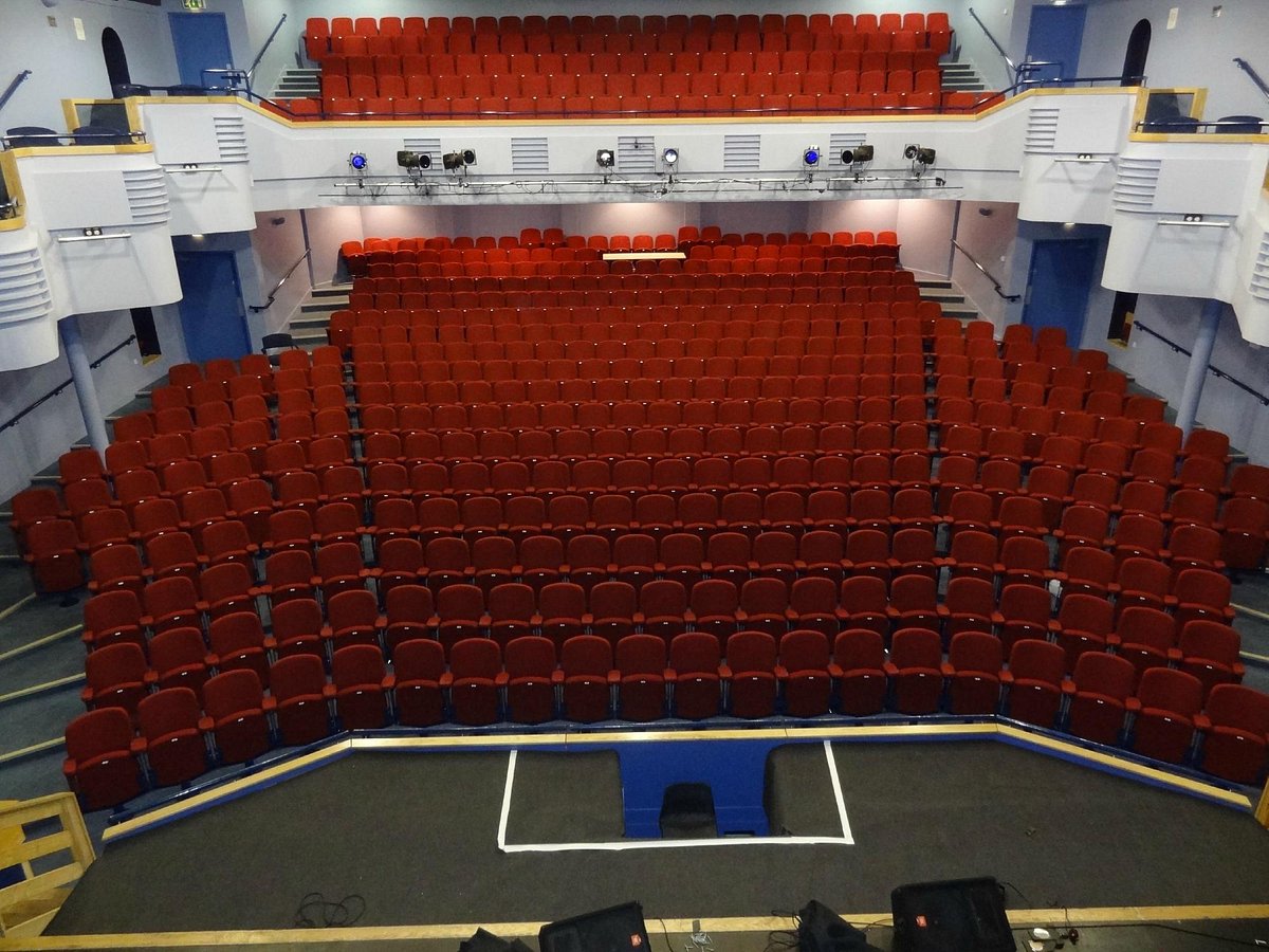 Lighthouse Theatre auditorium with tiered red seating for performances and presentations.