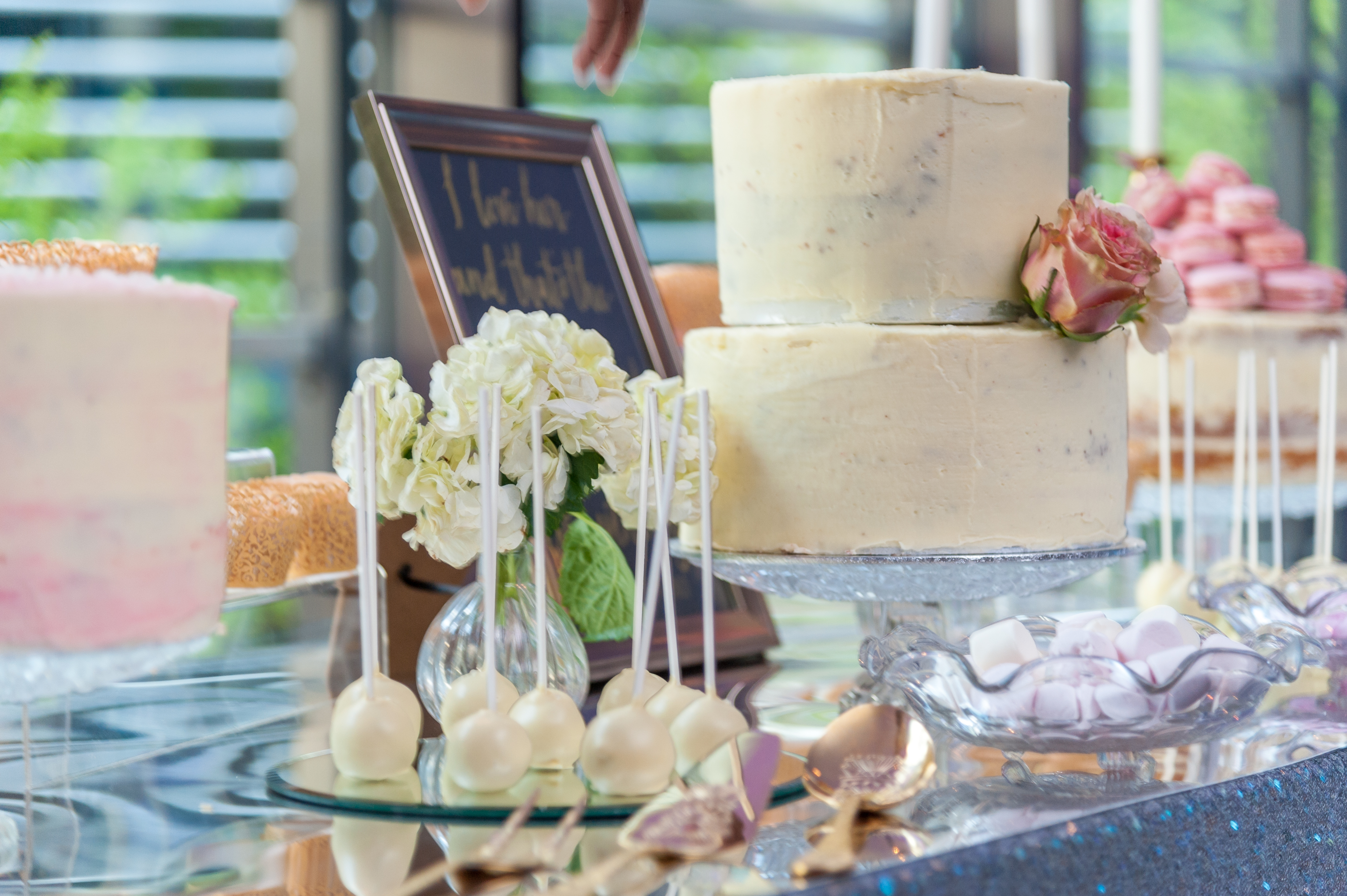 Elegant dessert table with two-tiered cake at Hilton London Tower Bridge for weddings.