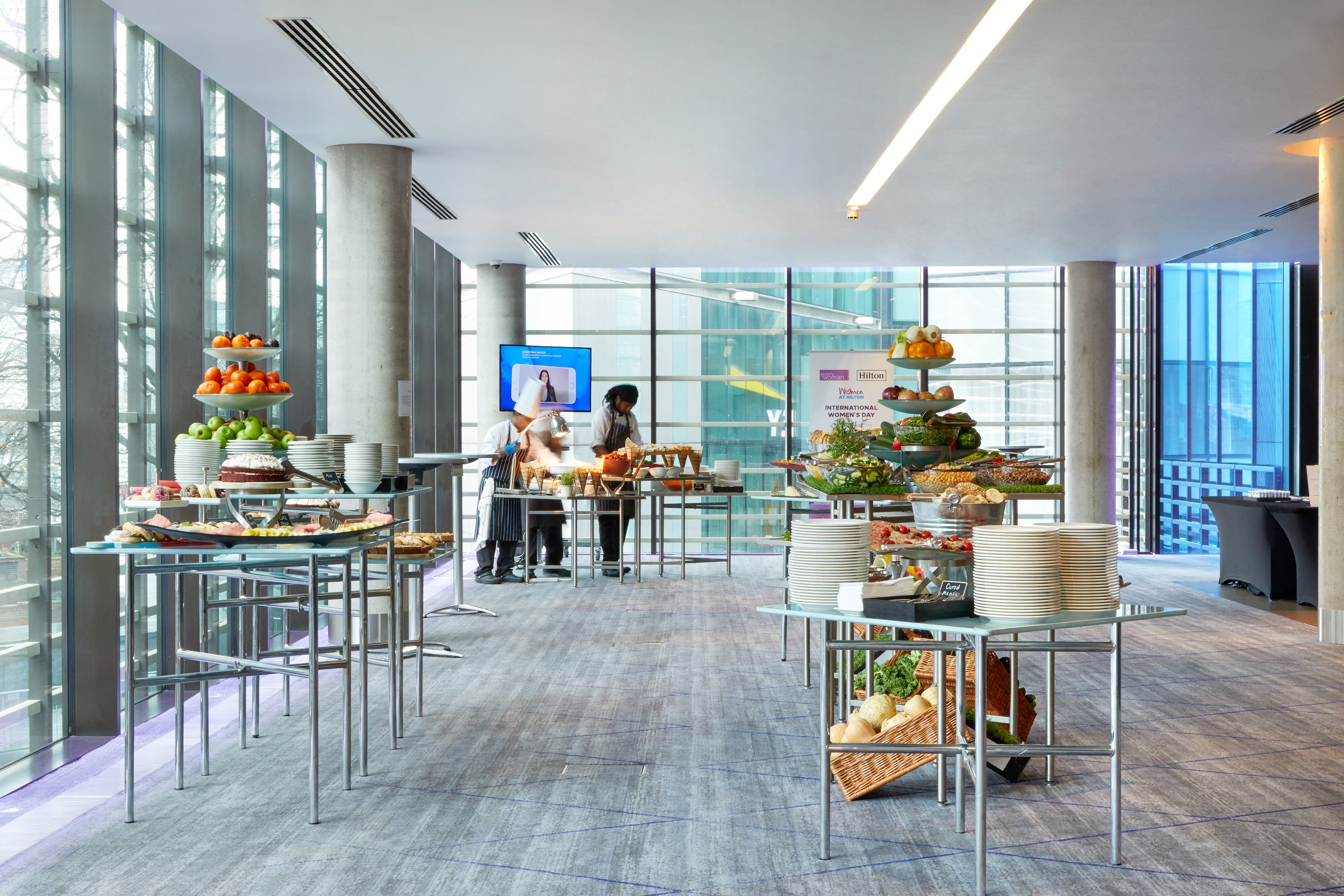 Modern event space in Hilton London Tower Bridge with elegant food stations for networking.