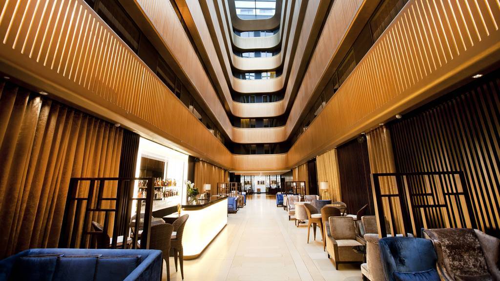 Modern hotel lobby with sleek bar, ideal for upscale events and networking.