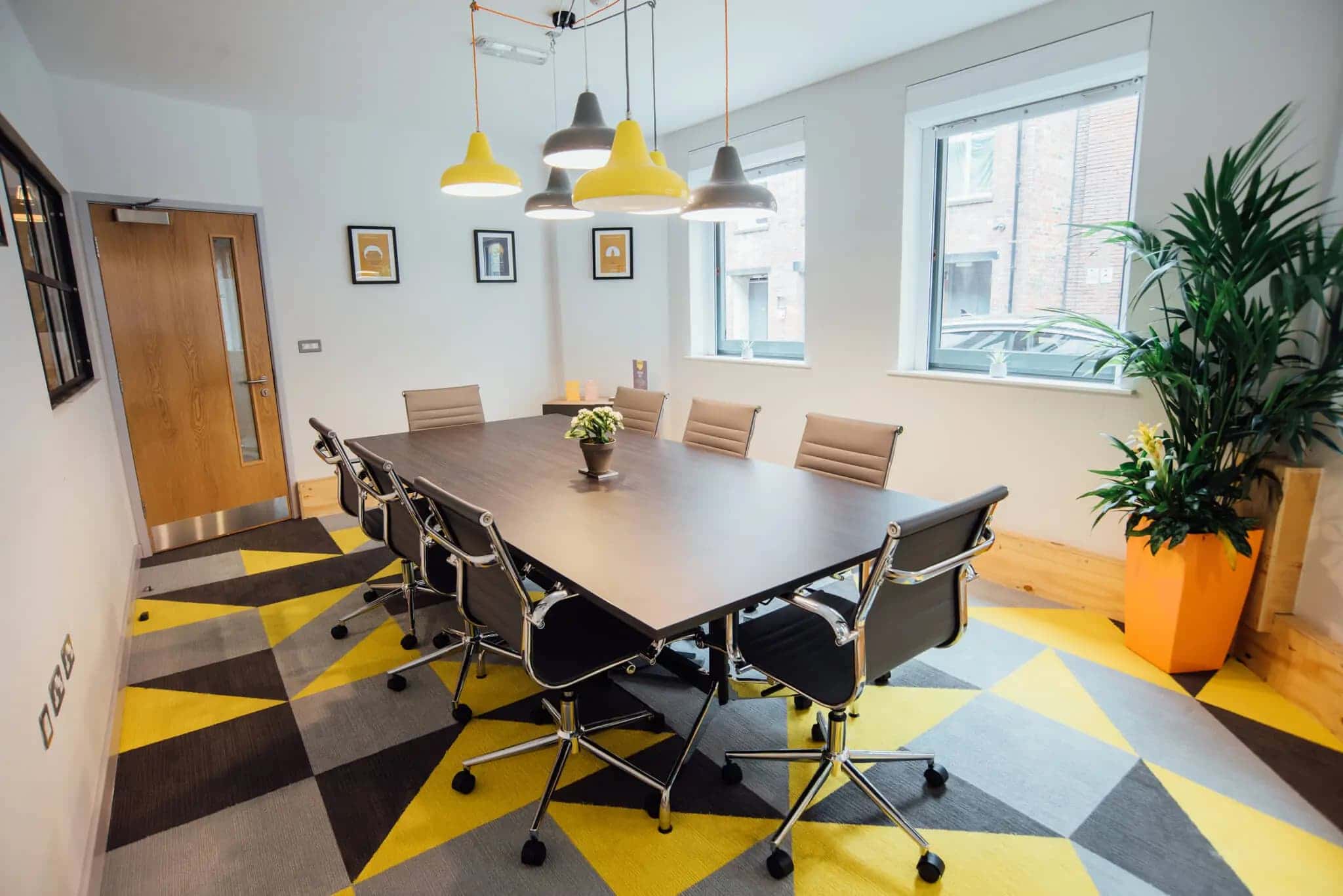 Modern meeting room with large table, ergonomic chairs for productive brainstorming sessions.