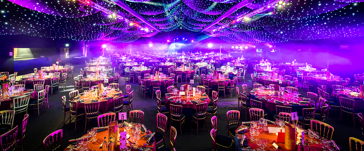 Elegant event space with vibrant centerpieces and twinkling lights for gala dinners.