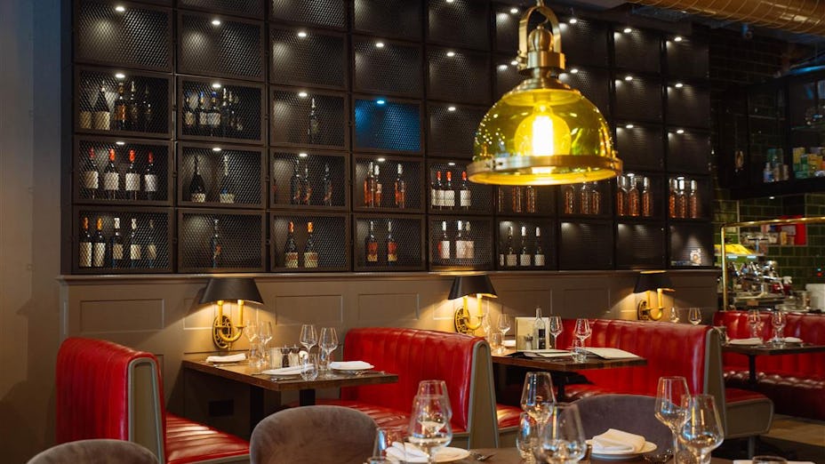 Stylish Kibele Restaurant interior with red banquettes, ideal for networking events.