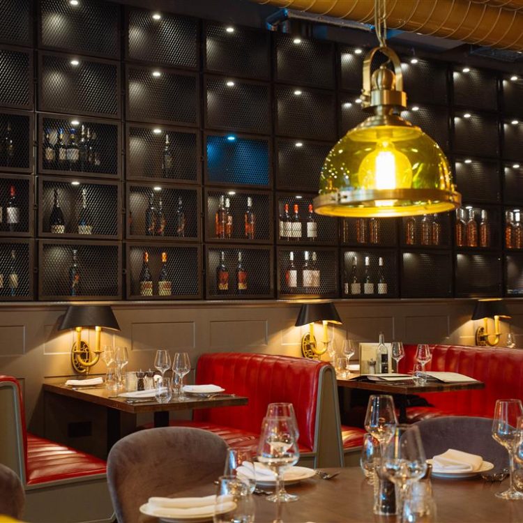 Stylish Kibele Restaurant interior with red booths, perfect for corporate dinners and gatherings.