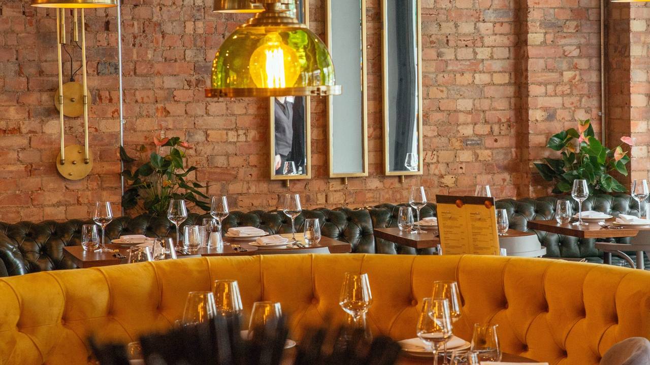 Kibele Restaurant's vibrant yellow seating, ideal for intimate gatherings and corporate events.