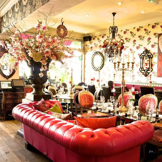 Elegant Rock & Rose Restaurant with floral wallpaper, perfect for upscale events and gatherings.