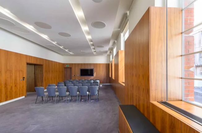 Modern Lovelace Room at IET London, featuring wooden paneling for workshops and meetings.