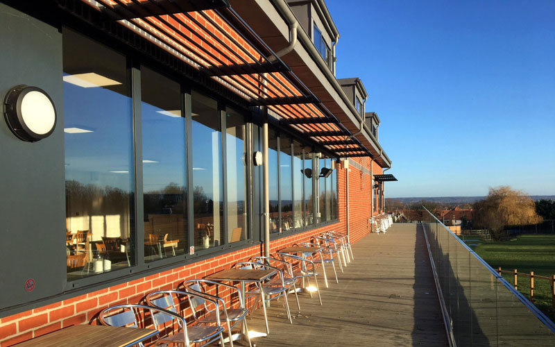 Modern Clubhouse at Rosedale Sports Club with expansive windows, ideal for events and gatherings.