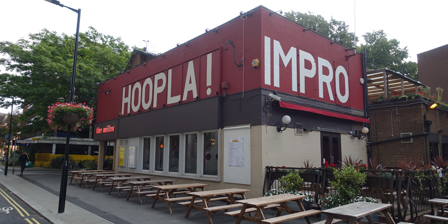 Vibrant pub exterior with outdoor seating, ideal for creative events and gatherings.