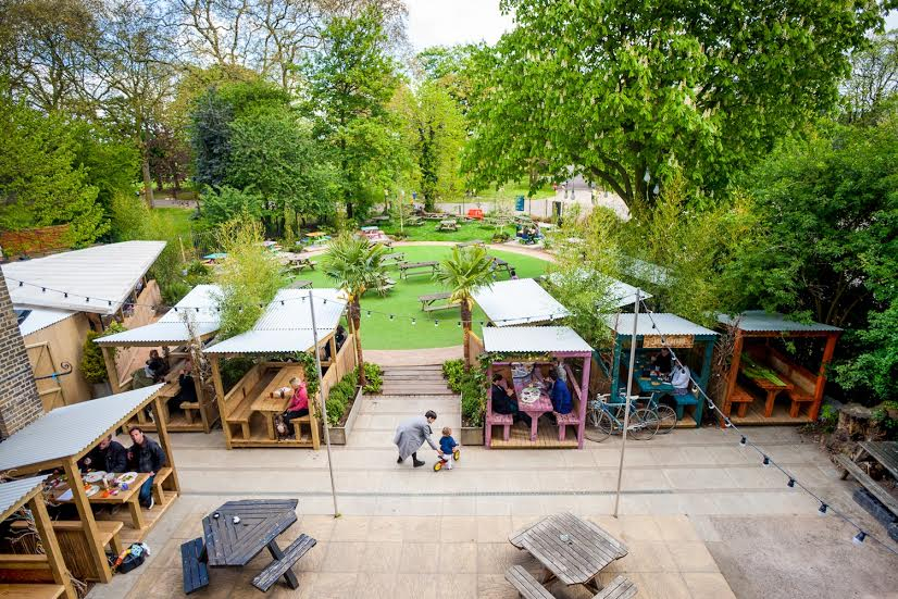 Vibrant beer garden at The Victoria with cozy seating for casual events and gatherings.