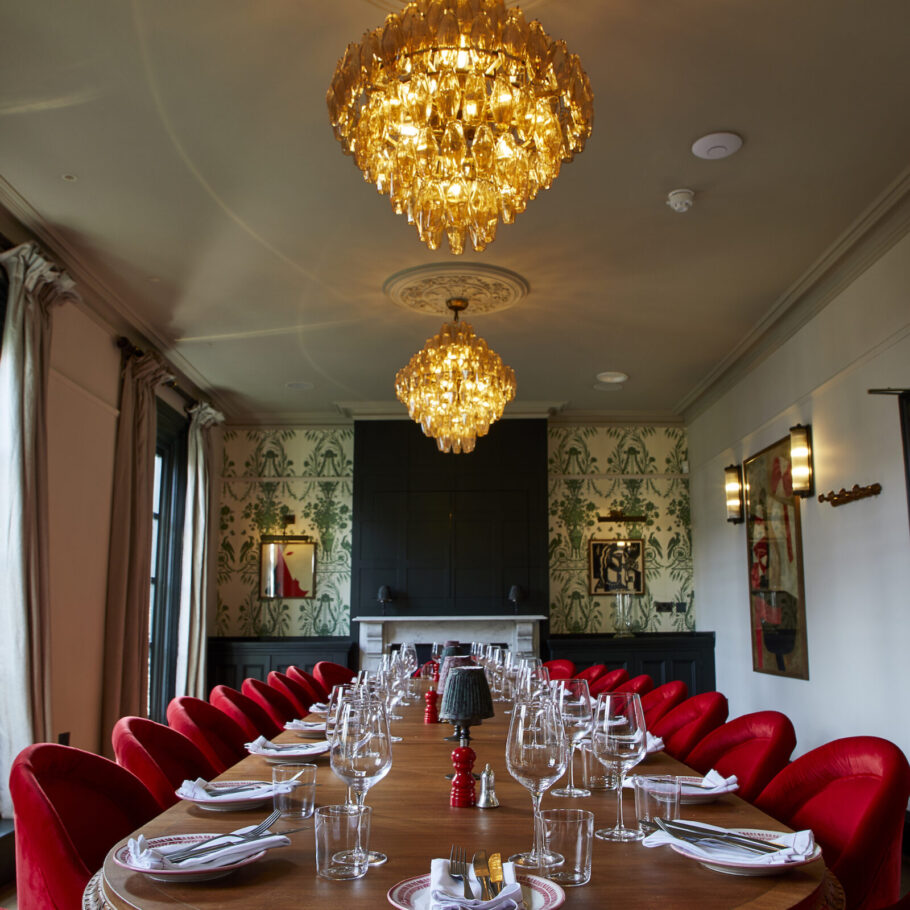 Private dining space with elegant chandeliers for corporate meetings and upscale dinners.