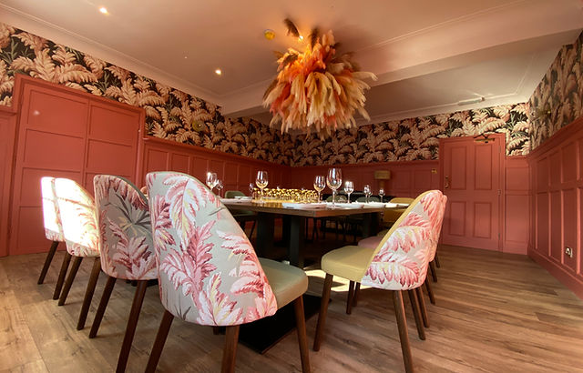 Elegant dining room with floral wallpaper, perfect for upscale events and private dinners.