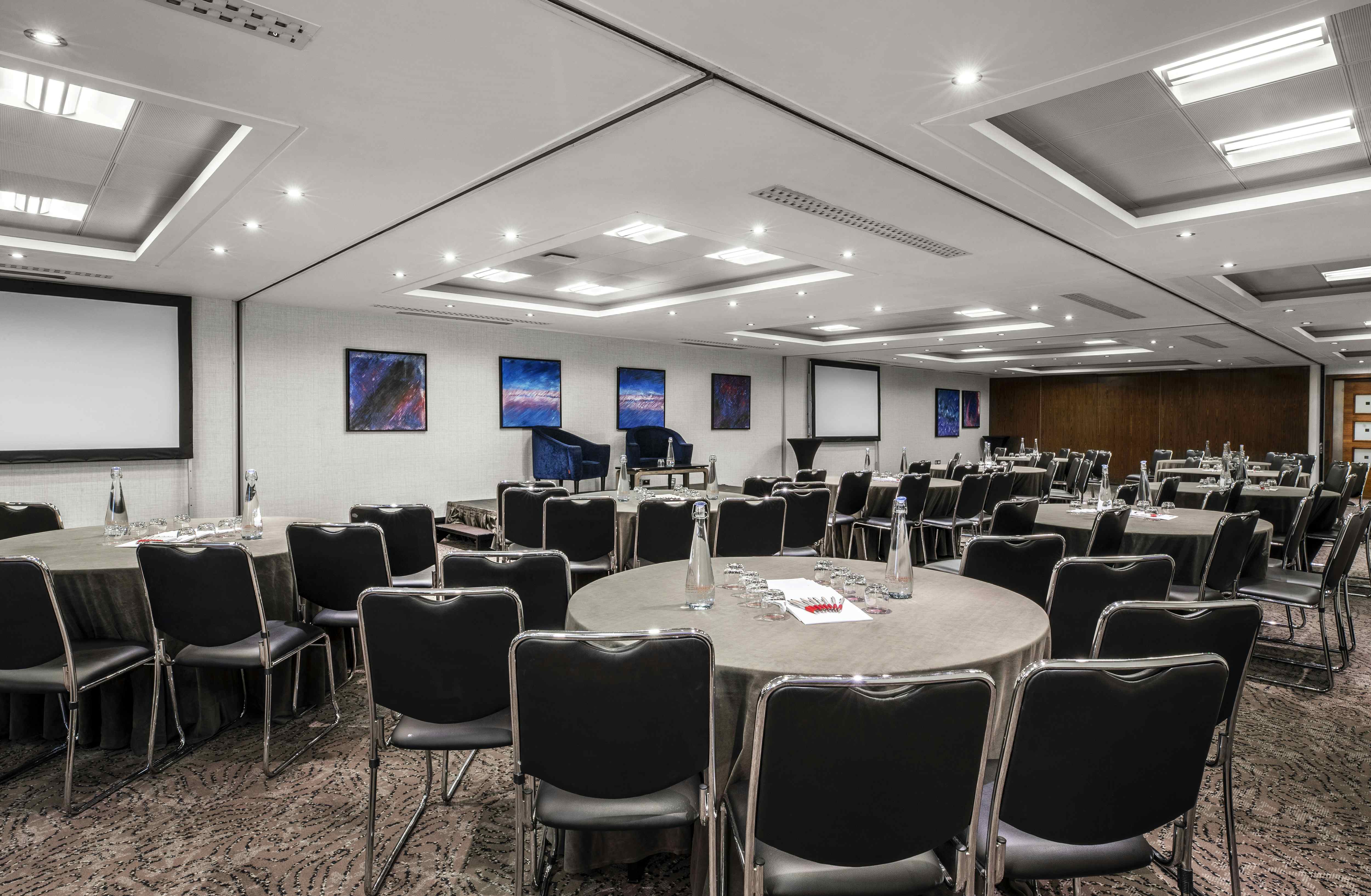 Conference Room at St Pauls Hotel with round tables, ideal for workshops and conferences.