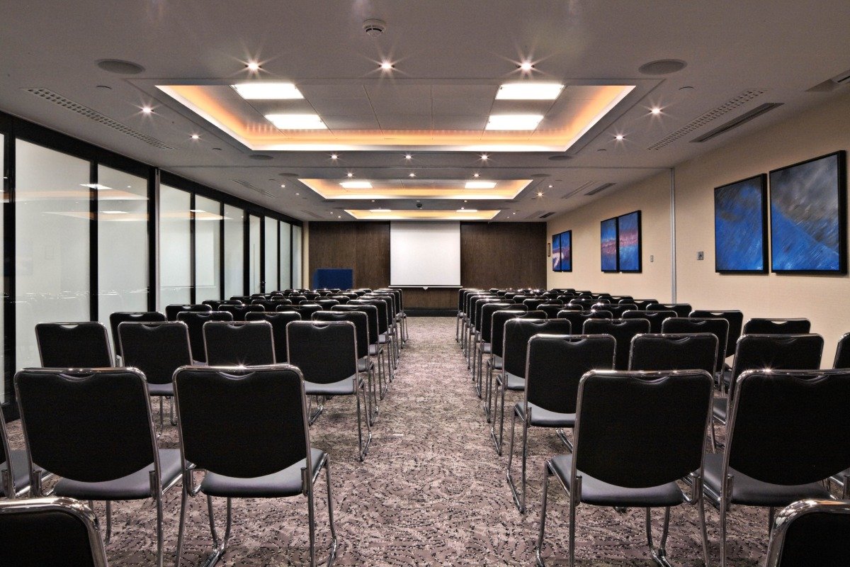 Meeting room at St Pauls Hotel with black chairs for presentations and events.