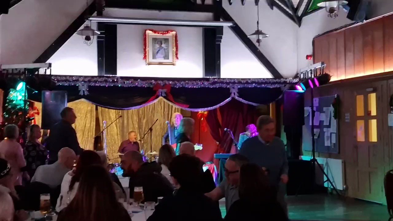 Snooker Hall at Bush Hill Park Club, festive stage setup for live music event.