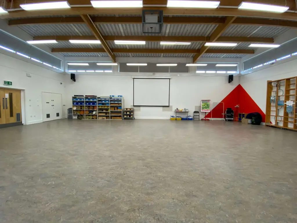 Versatile event space with large screen for meetings and workshops at Volume Unlimited.