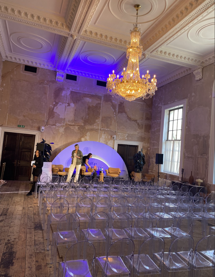 Stylish event space with modern seating for a panel discussion at Knotel Workclub.