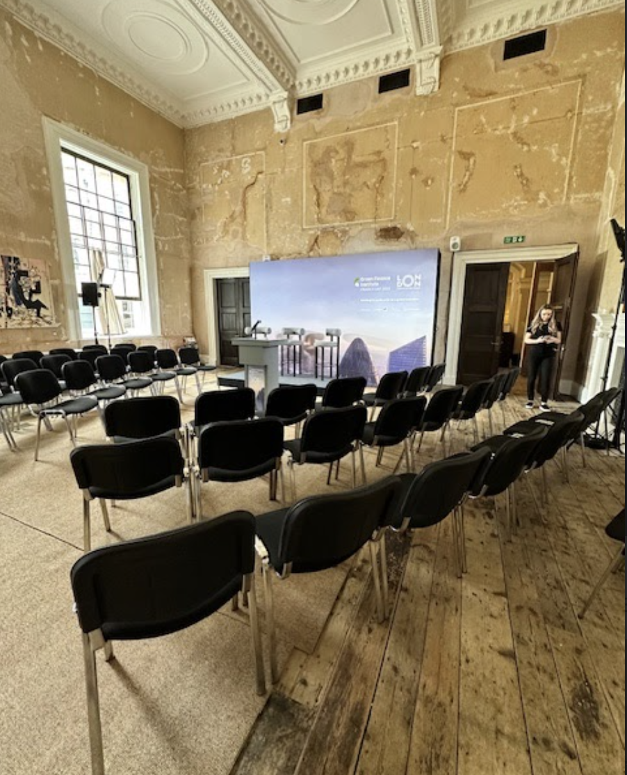 Event space with black chairs and podium for presentations at Knotel Workclub.
