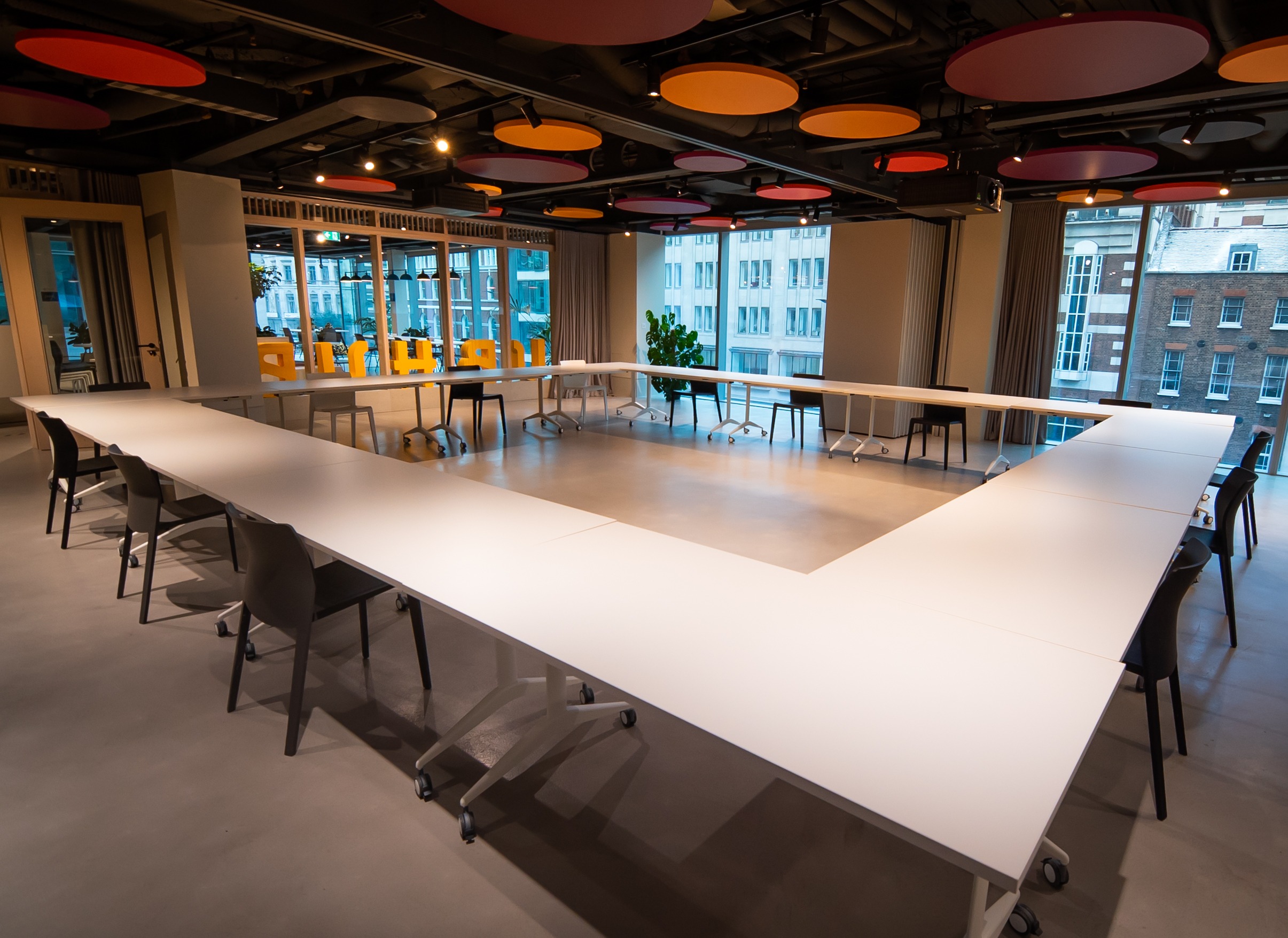 Modern meeting room with U-shaped layout at Christian Street Community Hub, ideal for events.