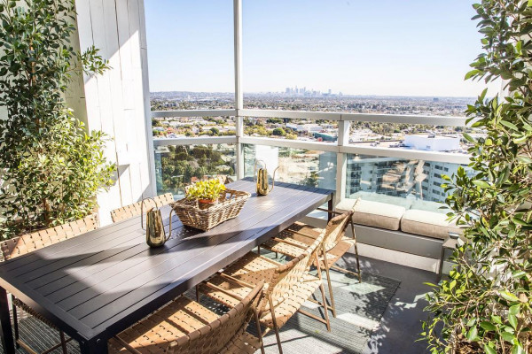 Stylish outdoor meeting space in Hills Penthouse, West Hollywood with city view.