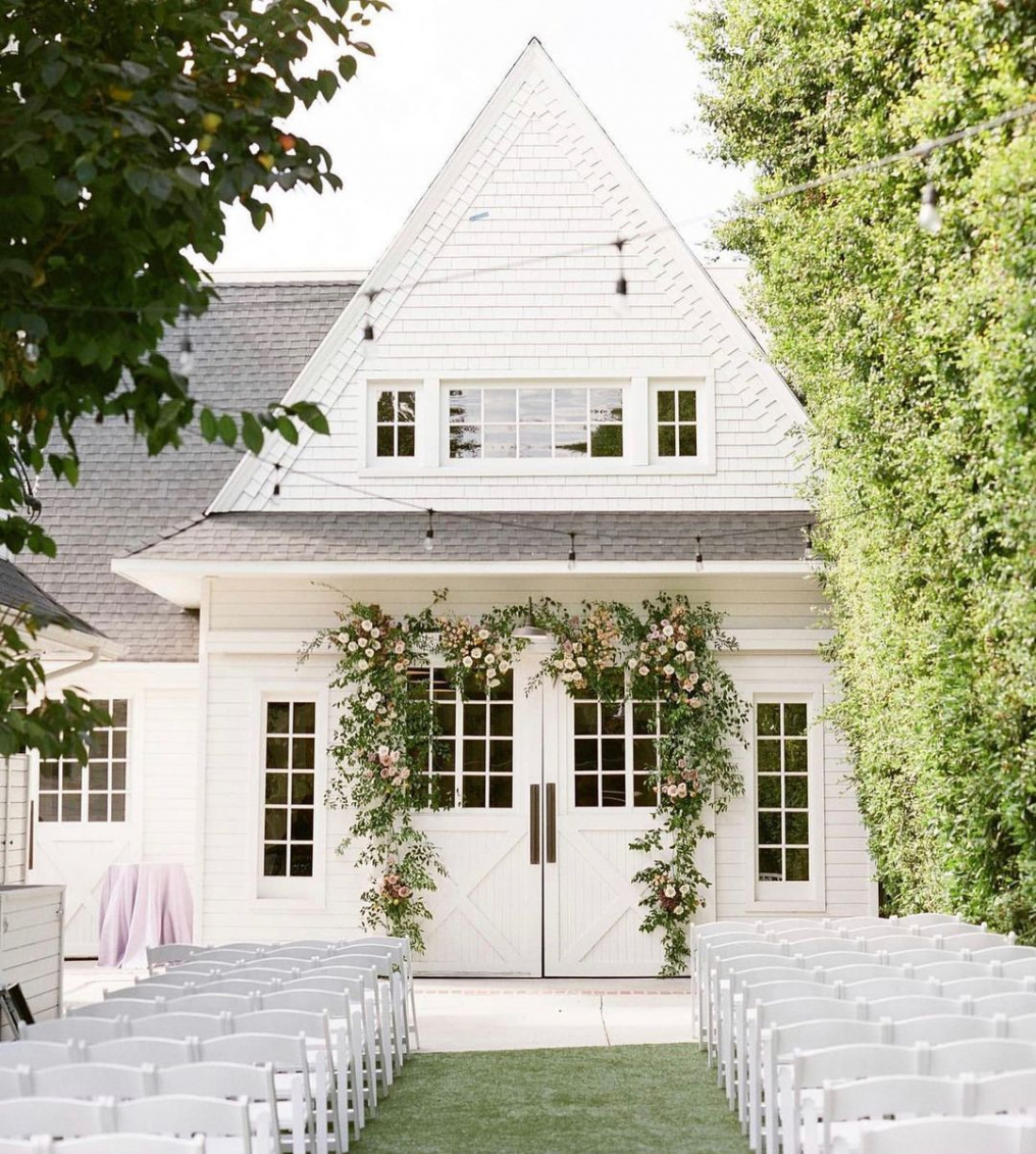 Charming Lombardi House entrance with greenery, ideal for weddings and upscale events.