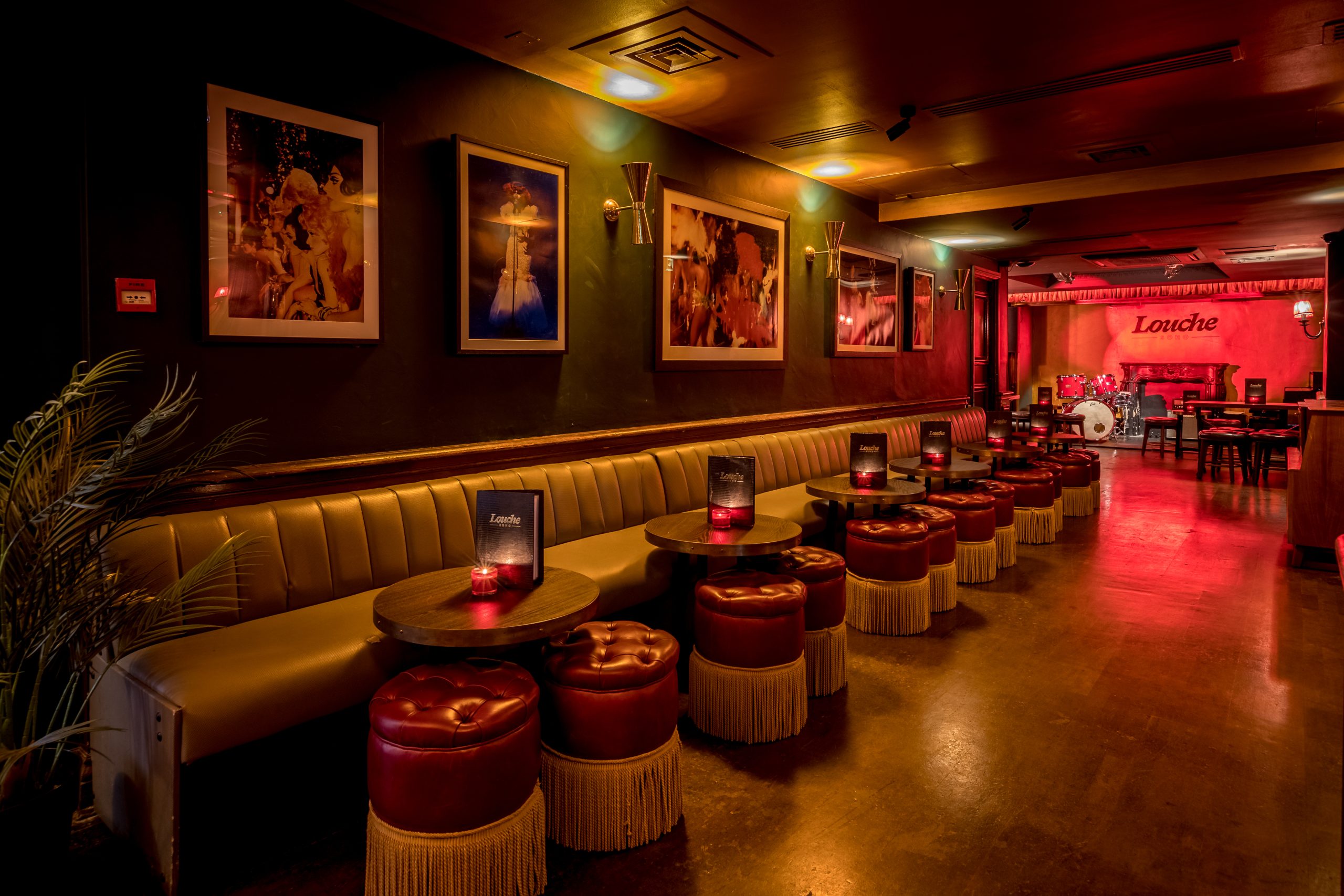 Stylish event space in Louche Soho with plush seating, ideal for cocktail receptions.
