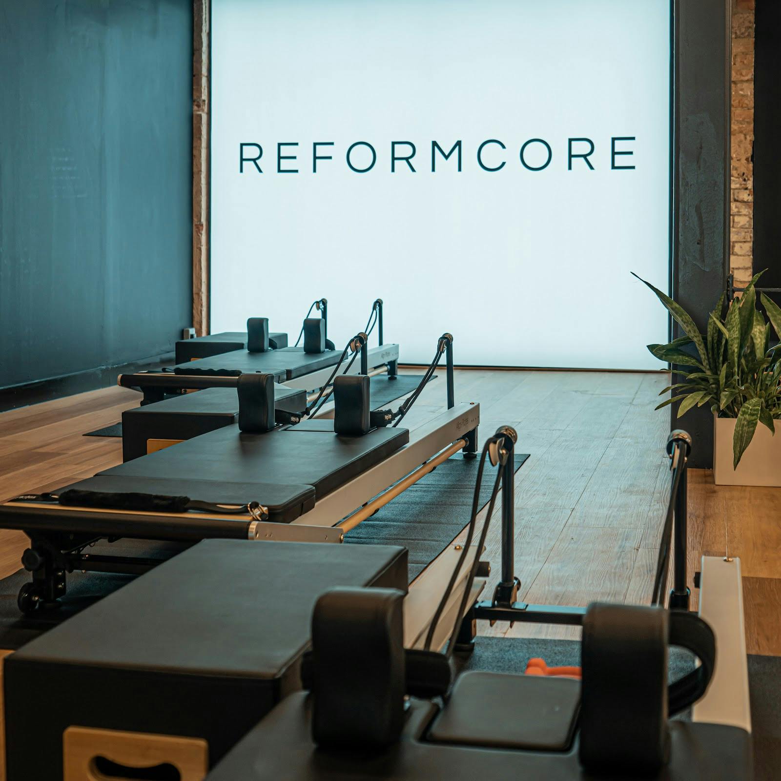 Modern fitness studio with reformer machines for wellness retreats and corporate events.