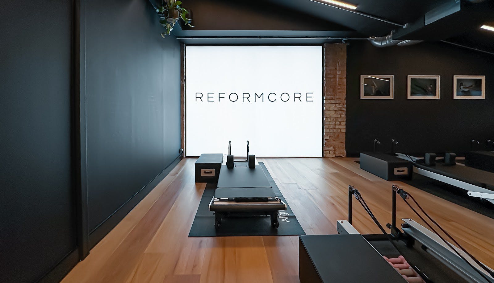 Modern fitness studio with reformer machines for wellness events and workshops.