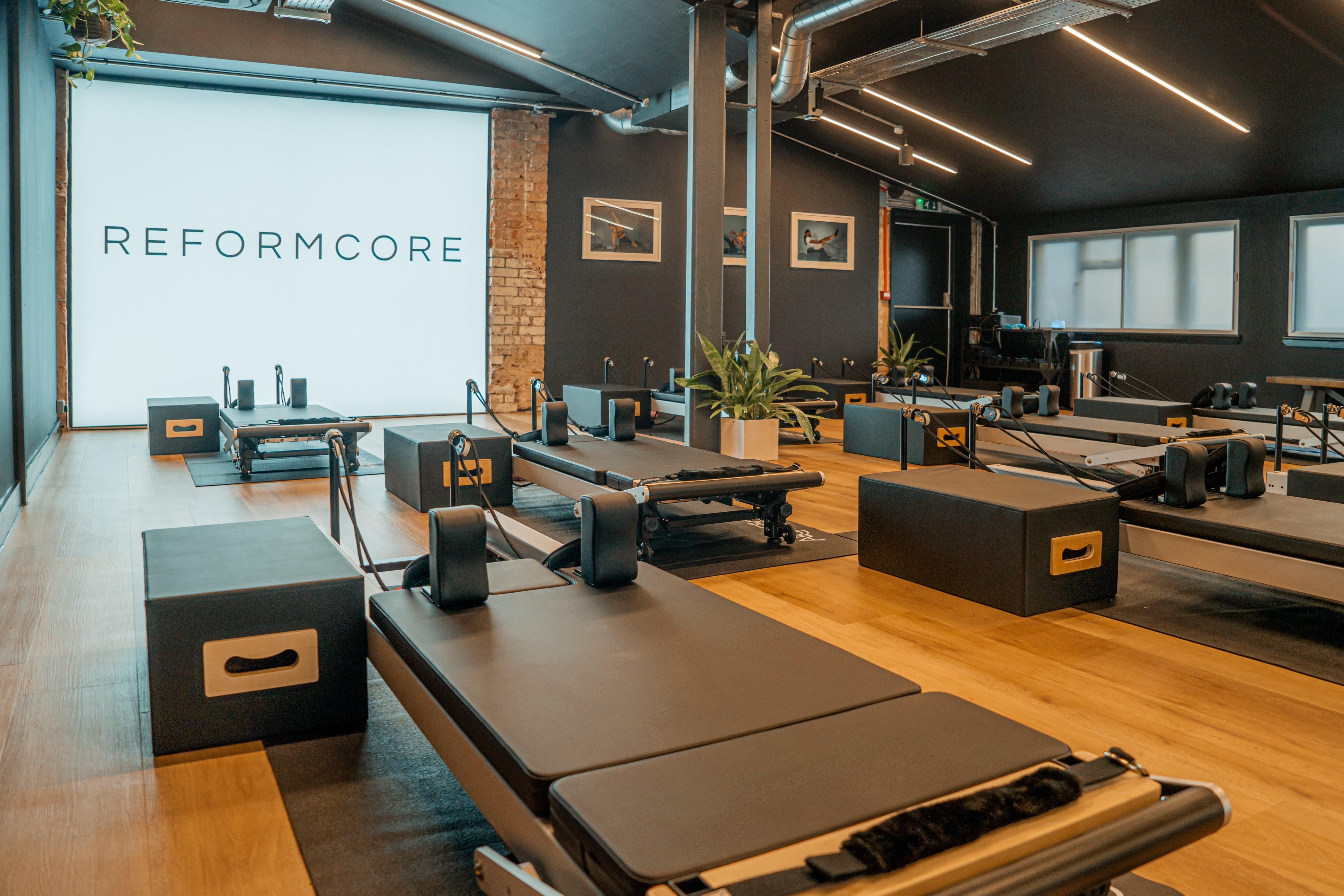 Modern fitness studio for reformer Pilates with sleek equipment, ideal for wellness retreats.