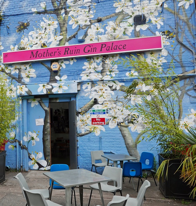 Pillars Brewery at Mother's Ruin Gin Palace with floral murals, perfect for events and gatherings.