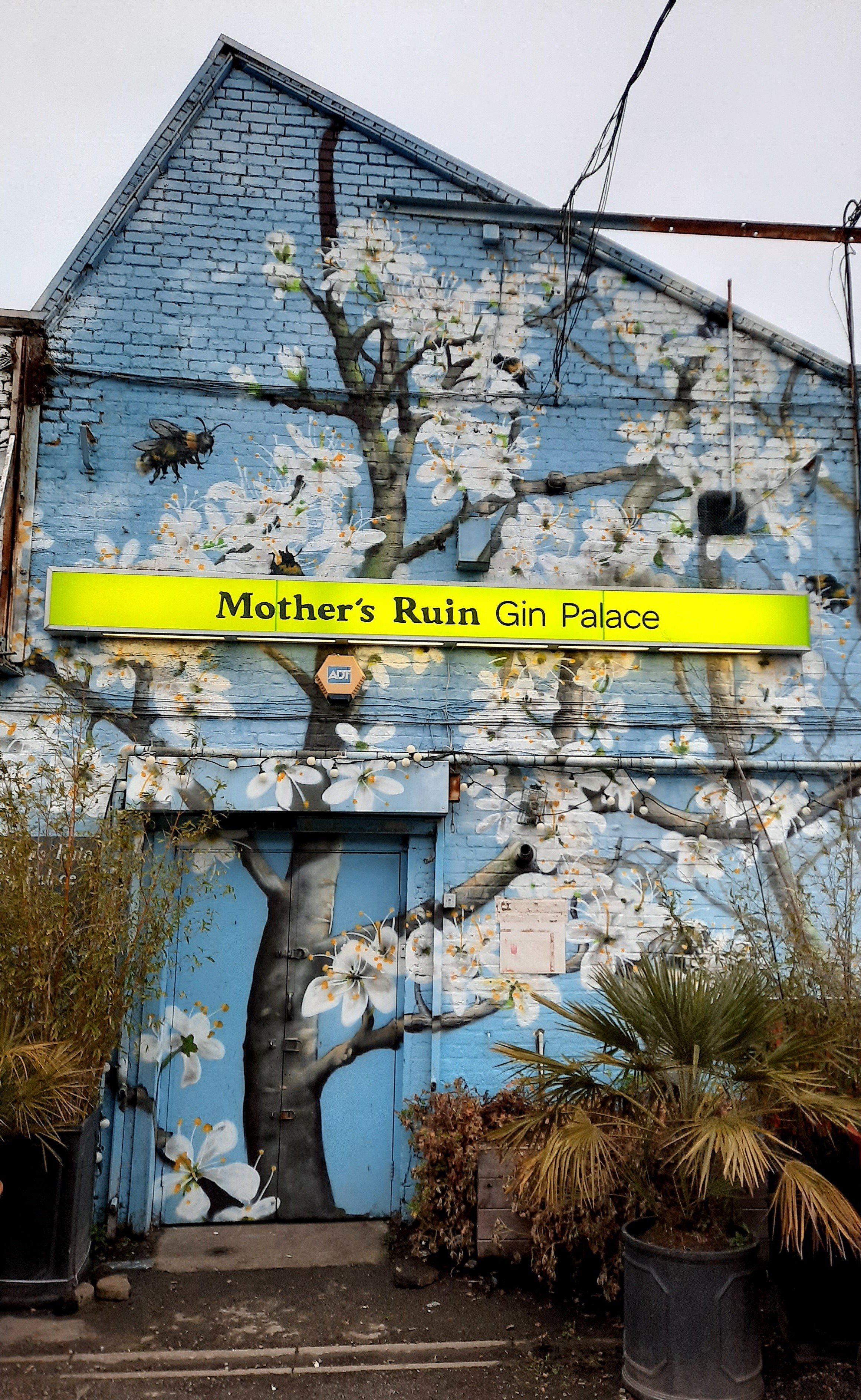 Pillars Brewery at Mother's Ruin Gin Palace with vibrant mural, ideal for events and parties.