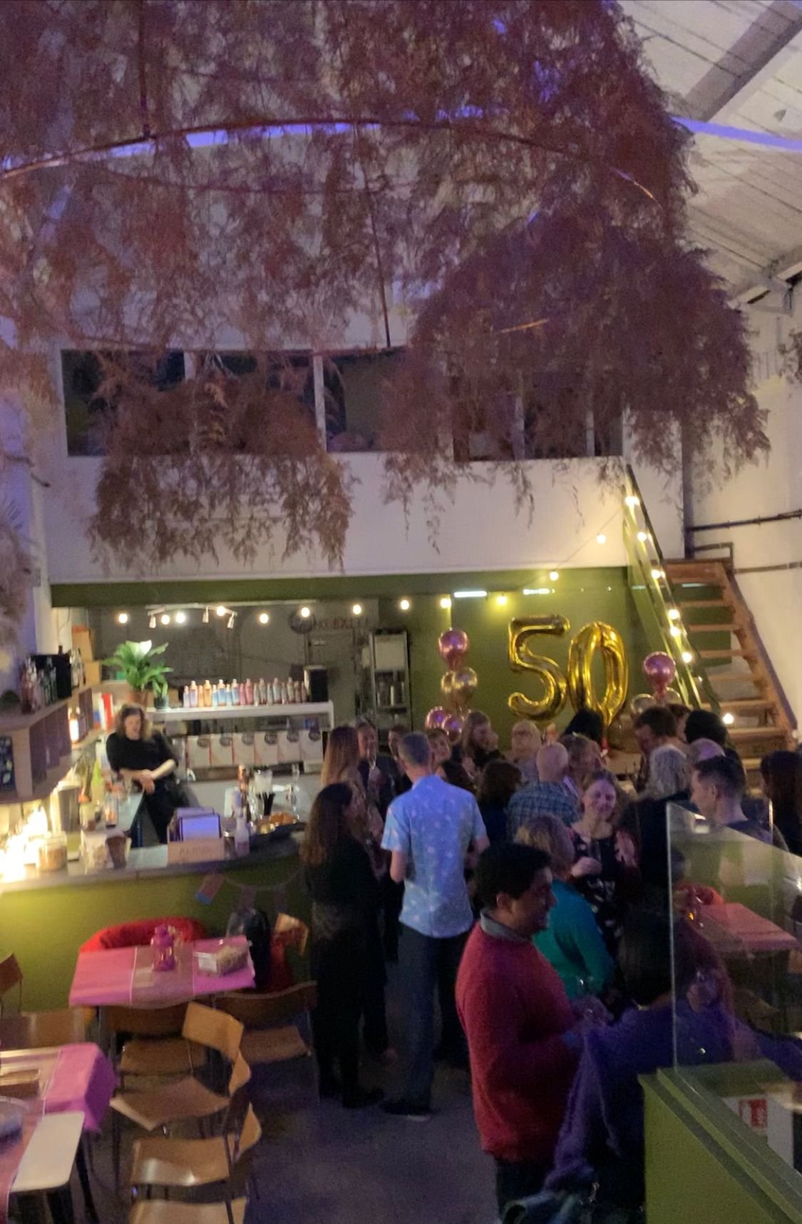 Pillars Brewery event space with golden "50" balloons for a milestone birthday celebration.