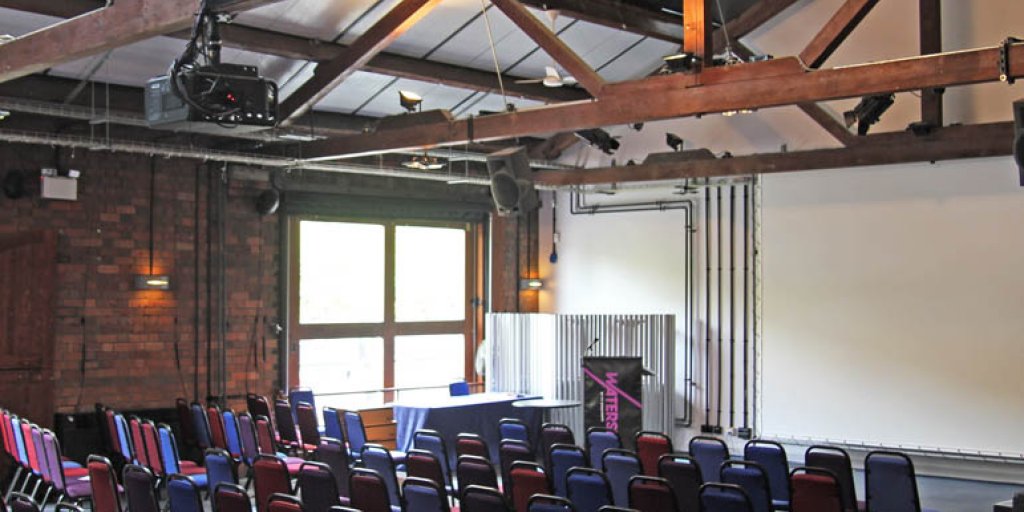 Versatile Watershed reception room with exposed beams for meetings and presentations.