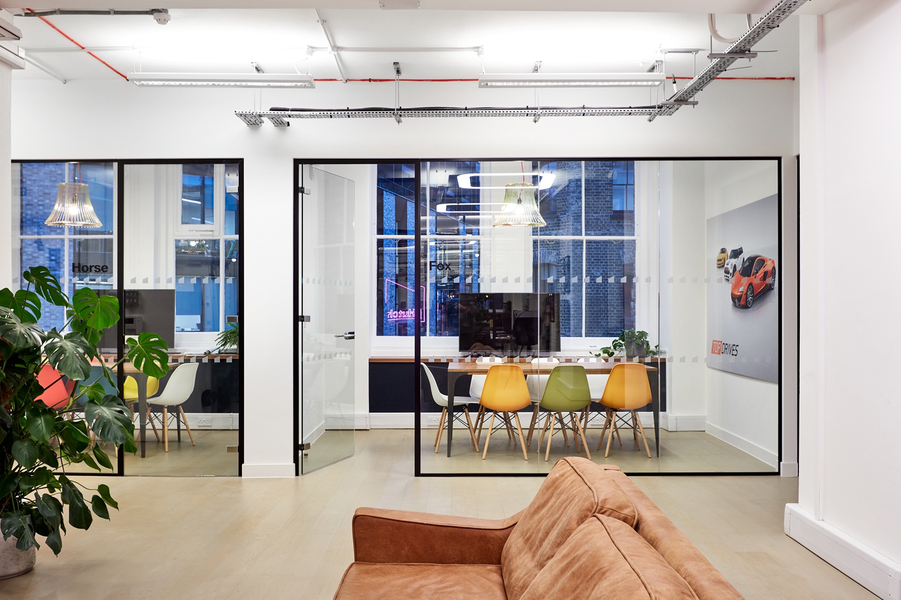 Modern meeting space with glass walls for collaboration at Hutch Games Ltd.