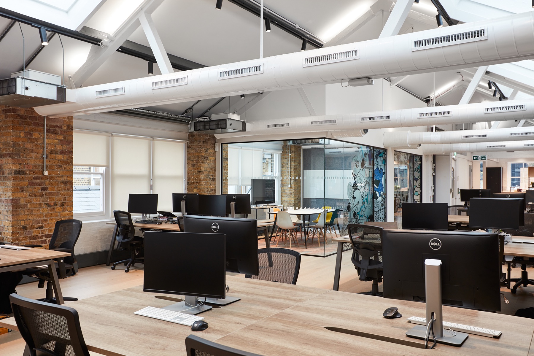 Modern open-plan office at Hutch Games Ltd. with natural light, ideal for workshops and meetings.